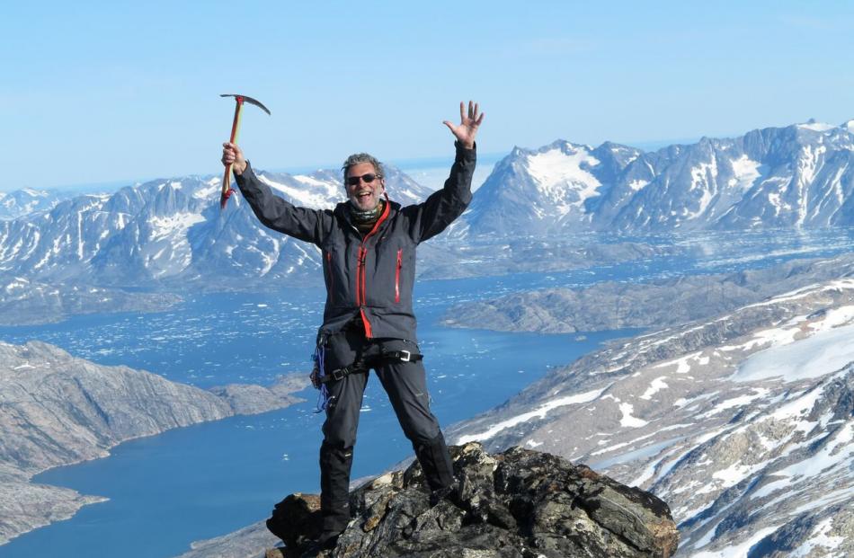 Mountaineer David Woods reaches the peak of a never-before-climbed mountain in Greenland in 2013....
