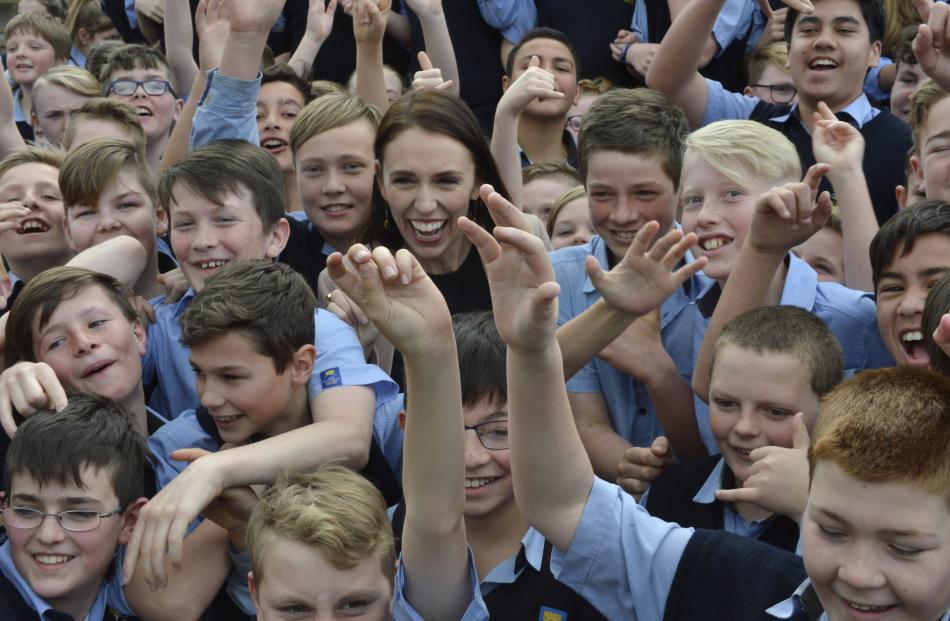 Labour leader Jacinda Ardern is mobbed by Taieri College pupils during a visit to the school...