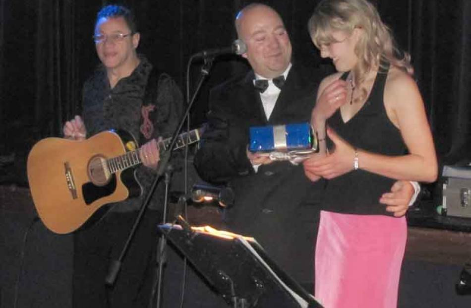 Chris Marr hands Kirsty Mann a token of appreciation for  organising the Ball.