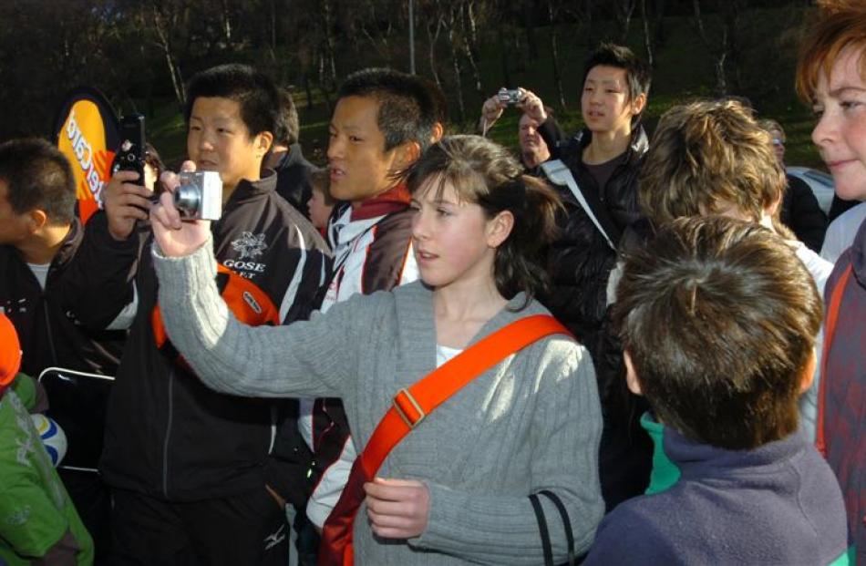 Ashlee Hammond, 13, of Dunedin taking photos during the All Black roadshow at the Oval on Friday....