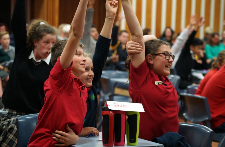 Pick me! Dorie School pupils (from left) Daniel Dolan (11), Brianna Sloper (12) and Billie Surridge (13) raise their hands in answer to a question during the quick-fire quiz section of the Otago Daily Times Extra! Central South Island years 7 and 8 quiz l