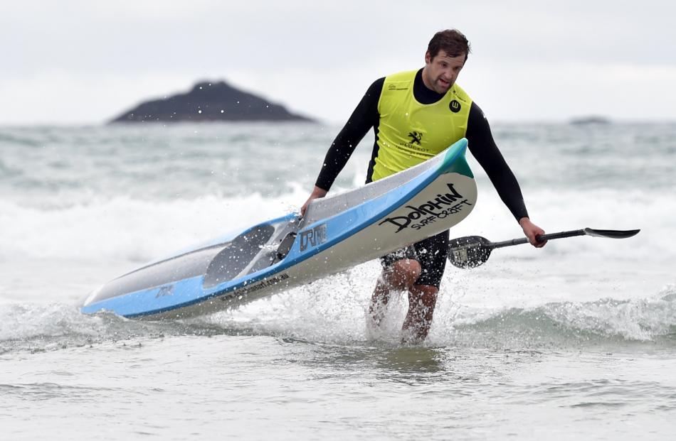 Surf ski event winner Andrew Newton, formerly of St Clair but now of Tauranga, arrives back on the beach. Photos: Peter McIntosh