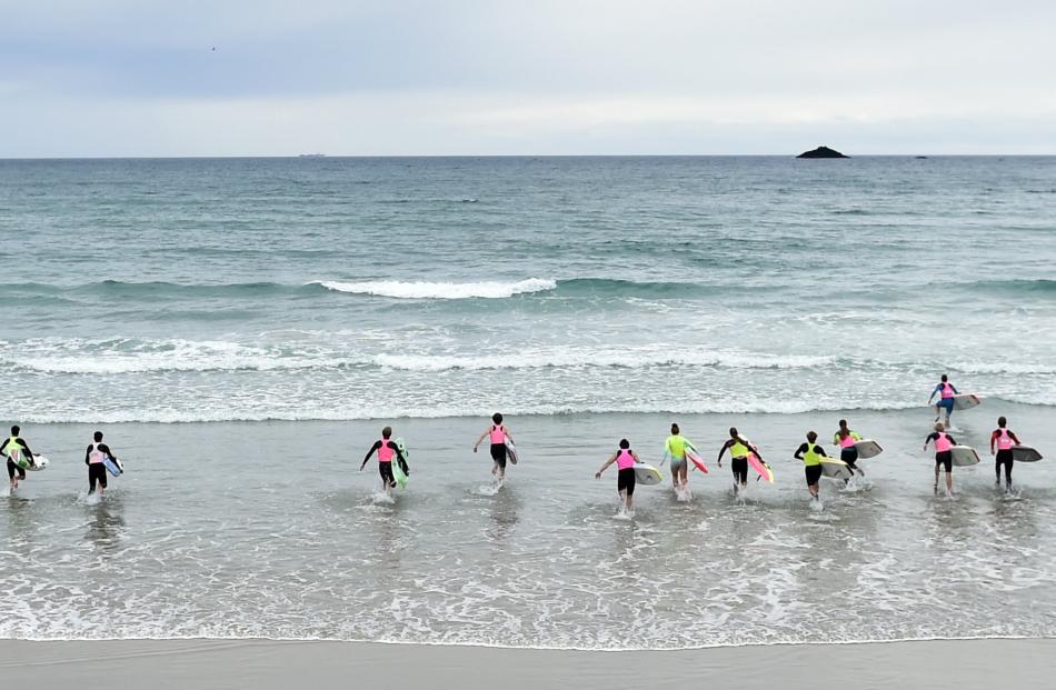 Competitors run into the St Clair Beach surf at the start of the annual White Island Race on Saturday.