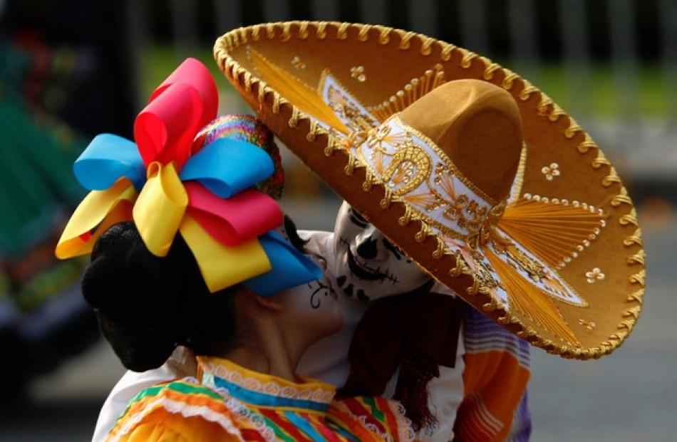 Although Mexicans typically celebrate Day of the Dead on November 2 in town plazas, homes and cemeteries, the Bond film's popularity prompted Mexico City officials to put on a carnivalesque spectacle. Photo: Reuters