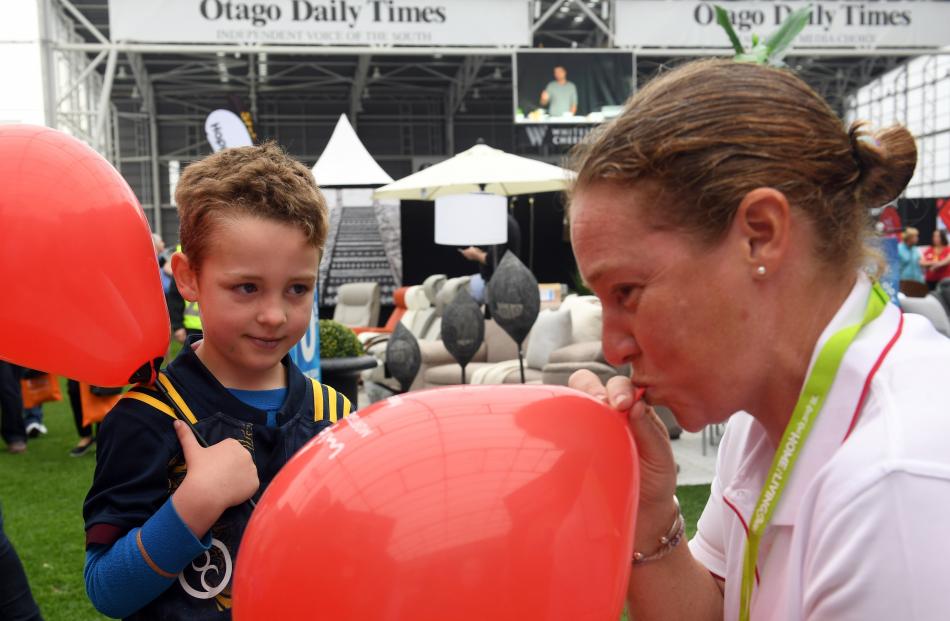 Isaac Wallace (5), of Dunedin, looks on as Charlotte Ireland, of Mike Pero Mortgages, blows up...