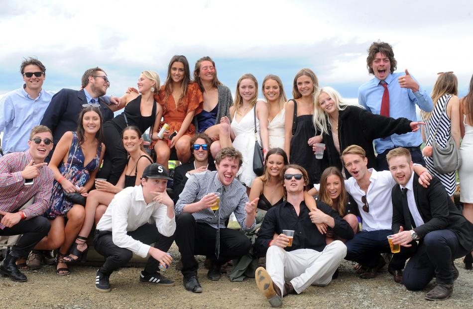 A group of young punters gather after the Melbourne Cup race was televised at the Wingatui event....