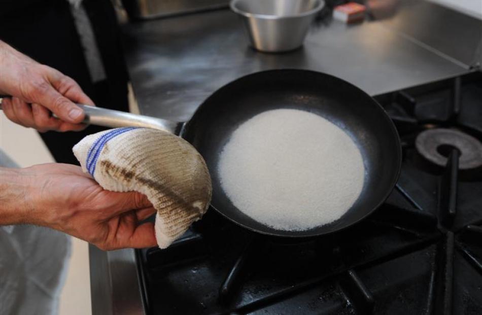 Hold the handle to steady it, and take care not to touch the salt, which may reach 180degC....