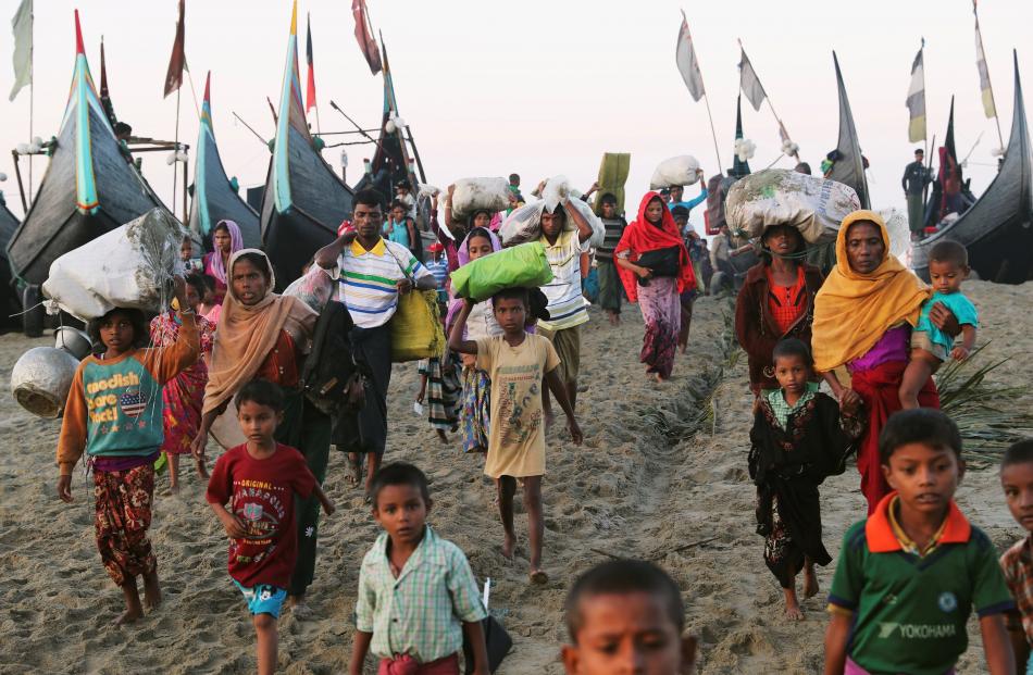 A group of Rohingya refugees, who fled from Myanmar by boat, walks towards a makeshift camp in Cox's Bazar, Bangladesh, earlier this month.