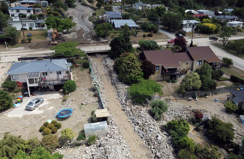 An image from a drone shows the extent of damage along Reservoir Creek, with tonnes of rocks lining the concrete culvert after Sunday’s flash flood. Photo: Craig Baxter