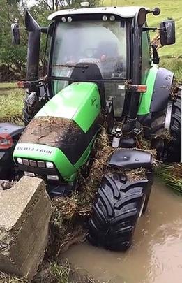 A tractor that was dumped in the creek by floodwater.