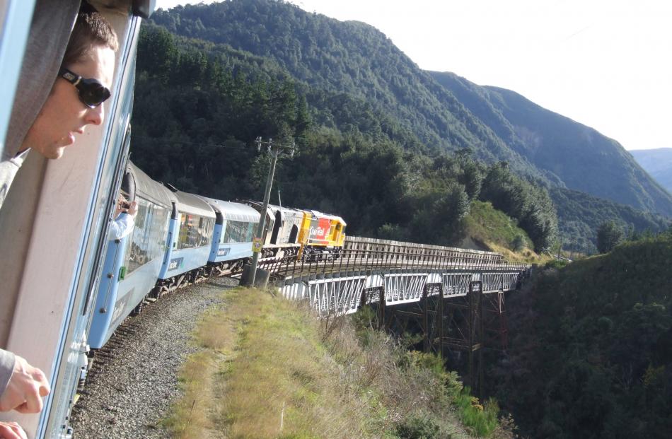 A passenger watches from the viewing deck as the Tranz Alpine pulls over one of four viaducts....
