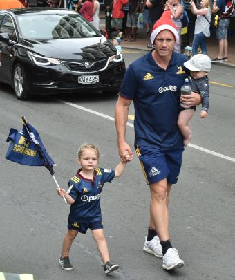 All Black and Highlanders fullback Ben Smith walks in the parade with his children Annabelle (2)...