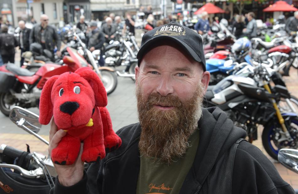 Nigel Dobson, of Dunedin, collects Christmas gifts for children in need in the Octagon yesterday. 