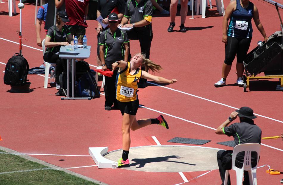 Zharna Beattie (15) gives it her all in her silver medal-winning throw during the junior girls...