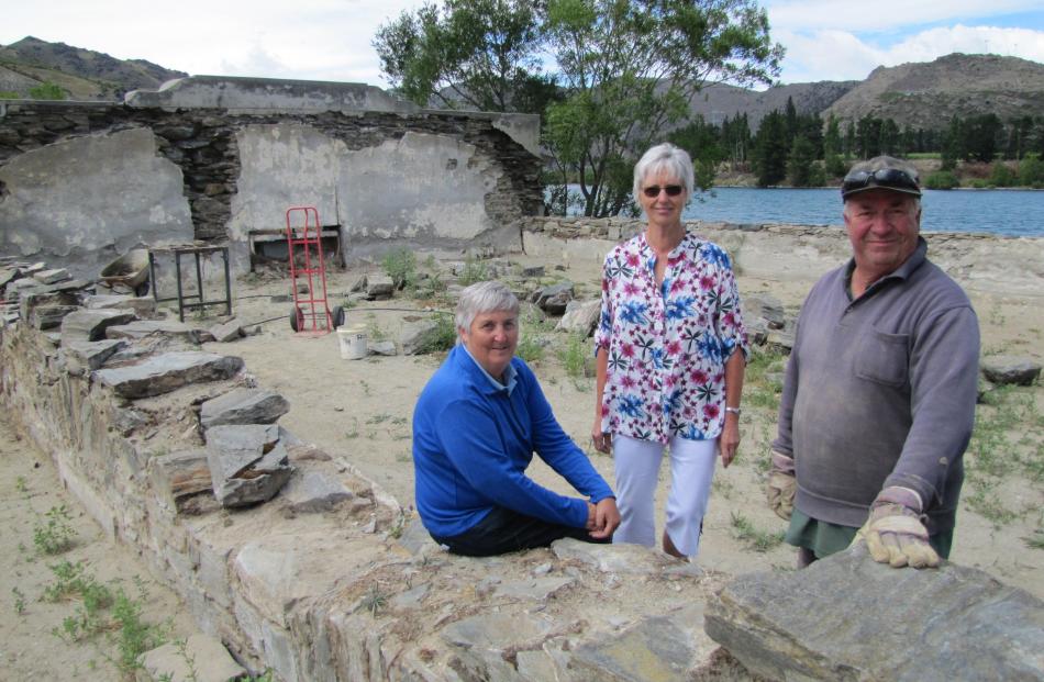 Old Cromwell Inc Society board members Helen Scoles (left) and Estelle Scott stand with heritage stonemason Keith Hinds, of St Bathans, at the restoration work on walls of the old Athenaeum Hall in the Cromwell Heritage Precinct. Photo: Pam Jones