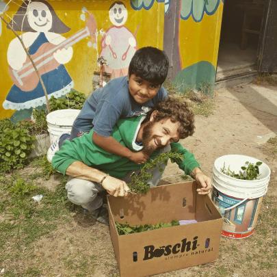 Ben Whitaker gets some assistance with gardening in Monte Chingolo, Argentina. Photo: Supplied