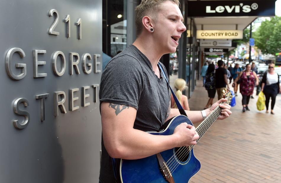 Josh Duckworth, of Dunedin, busks in George St.