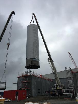 A silo is lifted by crane into position at Fonterra Clandeboye as part of the new mozzarella plant development. 