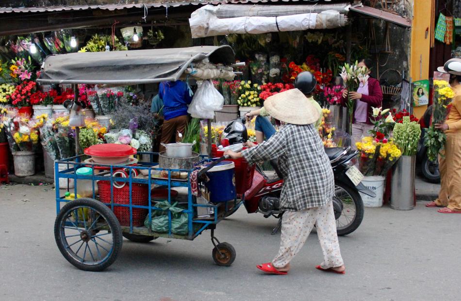 A street vendor with her mobile noodle stall.