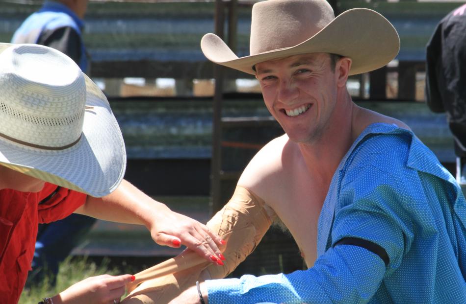 Omarama Rodeo’s Sam Gregory, of Christchurch, attends to second division bareback rider Arthur...