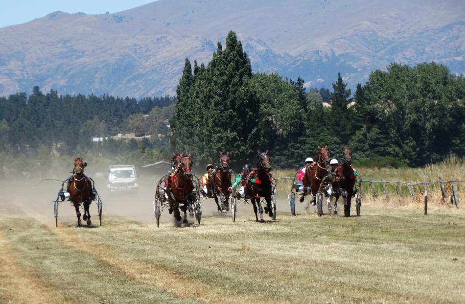 Loma Jaccka, of Southland Harness Racing (second from left), wins the first race of the day in a...