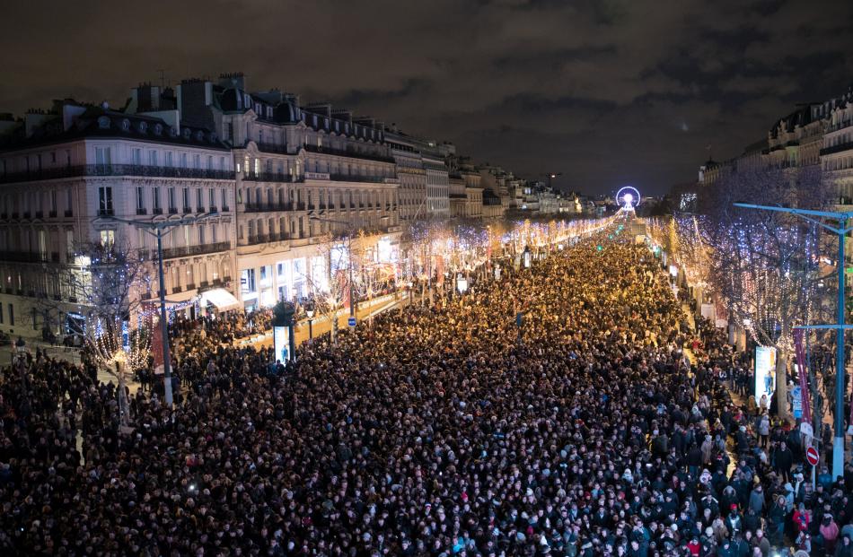 Crowds gather to celebrate the New Year along the Champs Elysees Avenue in Paris. Photo: Reuters