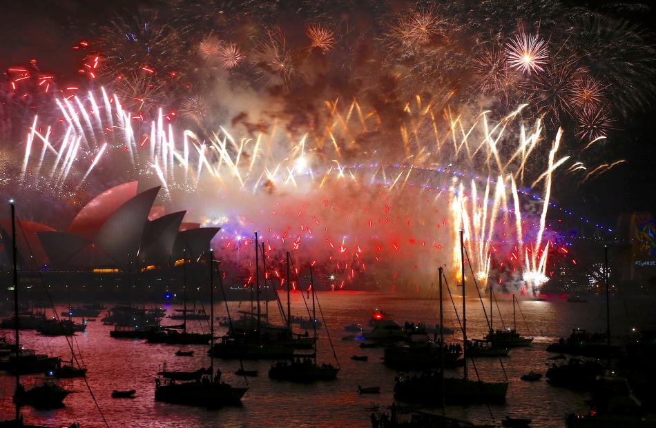 Fireworks light up the Sydney Harbour Bridge and Sydney Opera House during new year celebrations...