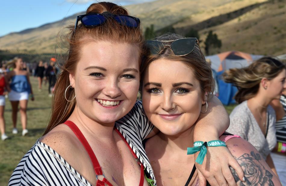 Leila Gillard (left) and Olivia Heslin, both of Oamaru, make the most of the hot weather at the festival