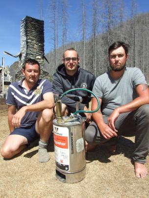 Queenstown friends (from left) Lee Gamble, Alan Wharton and Morgan Harteveld with one of the hand-pumped fire extinguishers they used to try to put out the fire which destroyed the historic Mount Aurum Homestead at the Skippers camping area near Queenstow