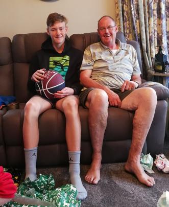 "`Poppa'' Geoff Davis, of Mosgiel, and grandson Mason Pringle (13), of Palmerston, compare the length of their legs on Christmas Day. Photo: Lois Davis