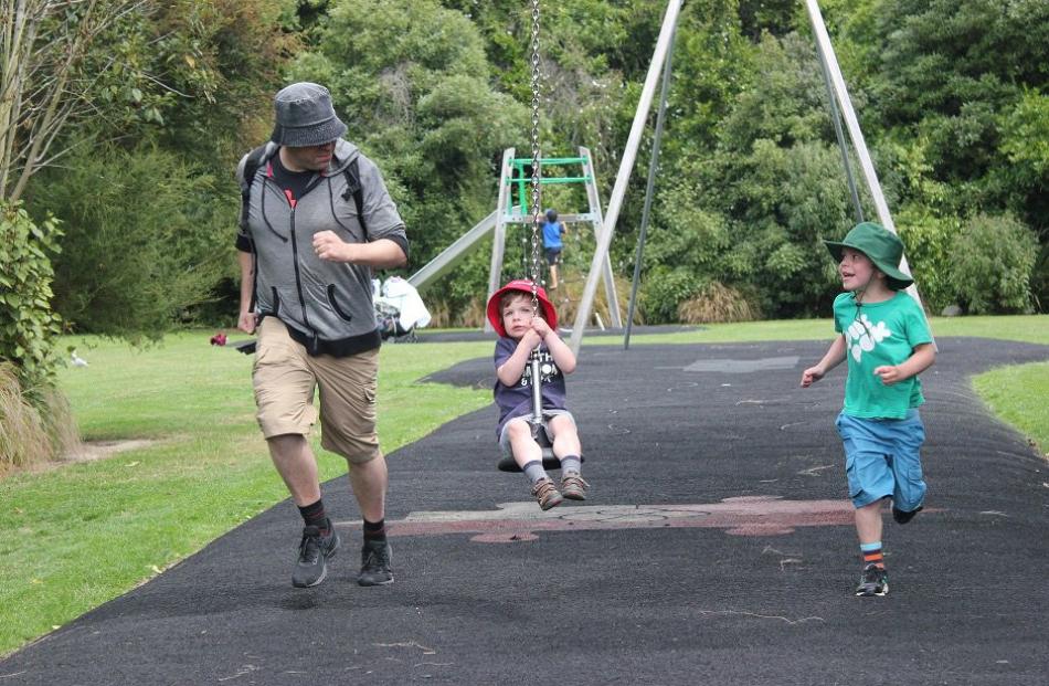 Samuel Rowse (6, right) and dad Andrew Rowse attempt to outrun Alexander Rowse (3) on the flying fox at Woodhaugh Gardens, Dunedin, on December 29. Photo: Susan Andrews