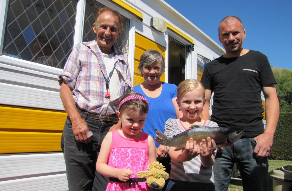Brooke McIntyre (8) shows off the fish she caught in the Clutha River to her sister, father and grandparents (from left) Jonny, Jaclyn (5) and Margaret and Scott McIntyre at the Millers Flat Holiday Park. Photos: Pam Jones