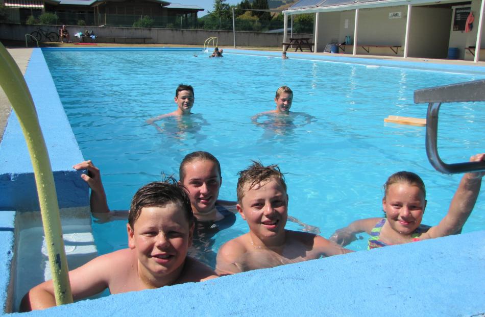 Cooling off in the Millers Flat community swimming pool are (front, from left) Sam White (12),...