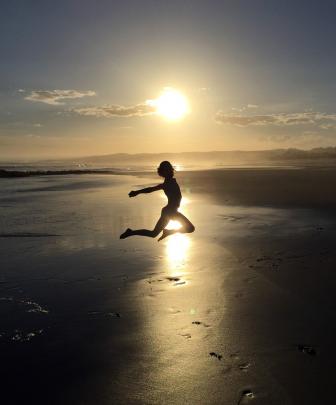 Isabel Martin (8), of Wanaka, jumps for joy at the start of the school holidays as the sun sets...