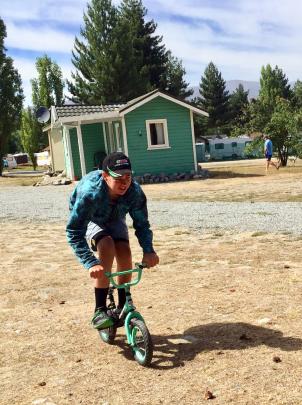 Jack Spriggs (14) tries out his old cycle at Lake Ruataniwha Holiday Park on December 29. Photo:...