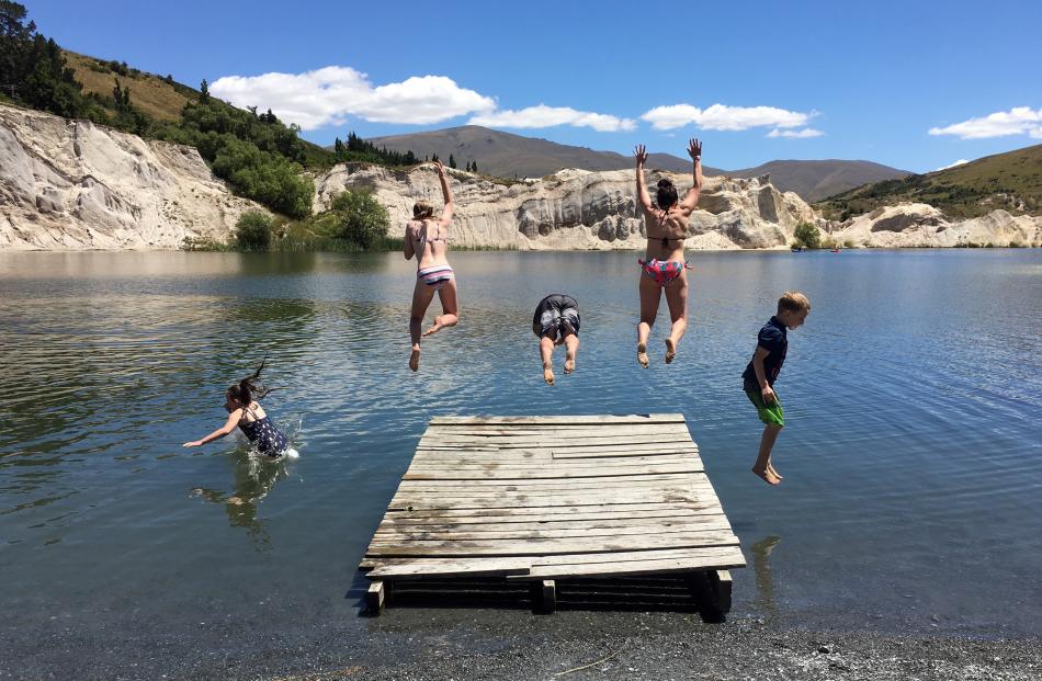 Braving the chilly water at St Bathans  on December 28  are (from left) Roree Latimer (9), Morgan...