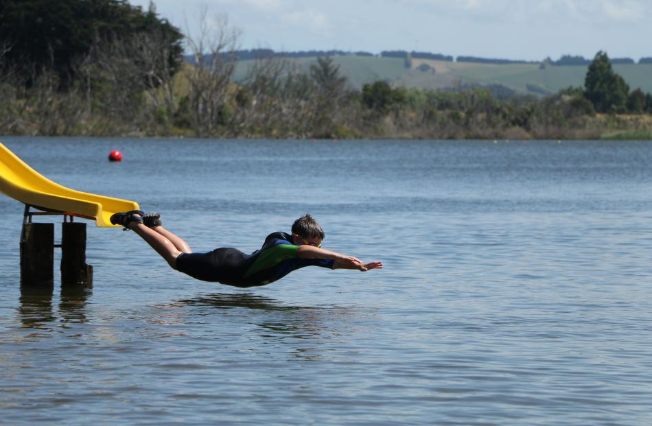 Matt Hurring (10) takes a New Year’s Day swim in Lake Waihola. Photo: Nik Hurring