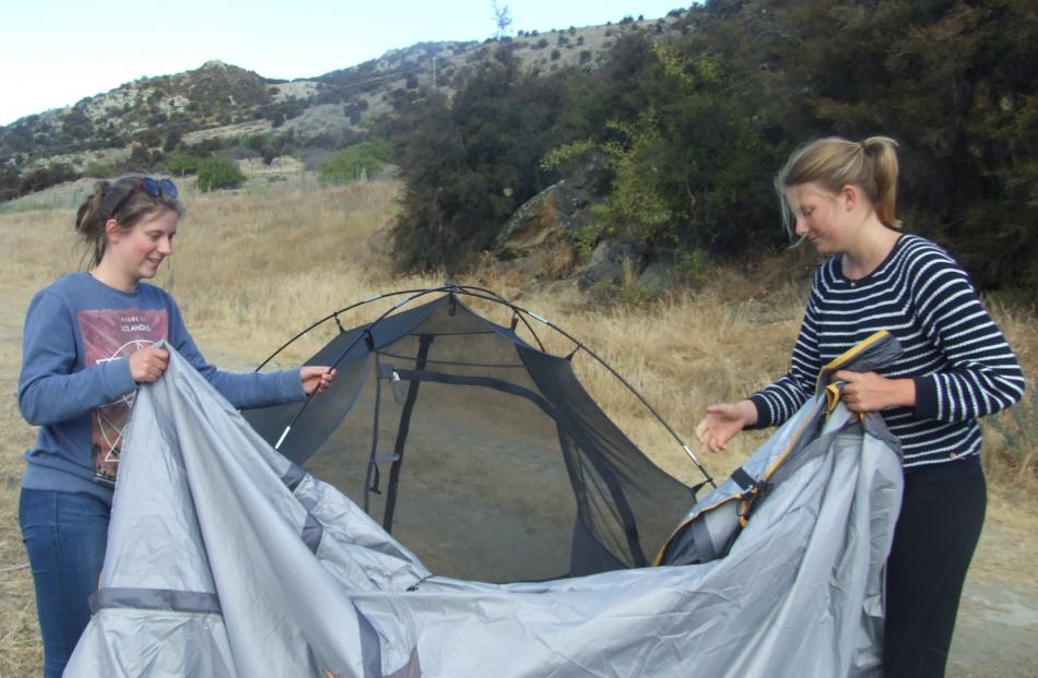 Setting up a home for the night are Katrin Schramm (left) and Alicia Altendeitering, both of...
