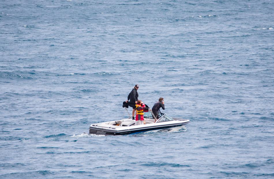 Searchers scour Lake Wakatipu for the missing skydiver. Photo: James Allan