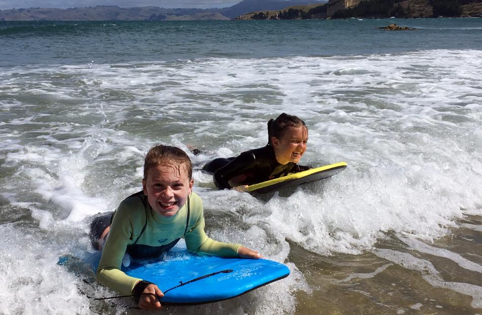 Annabel (11, left) and Isla (8) Ludgate enjoy their bodyboards in the surf at Karitane Beach, on a day trip up from their home in Dunedin. Photo: Jackie Ludgate