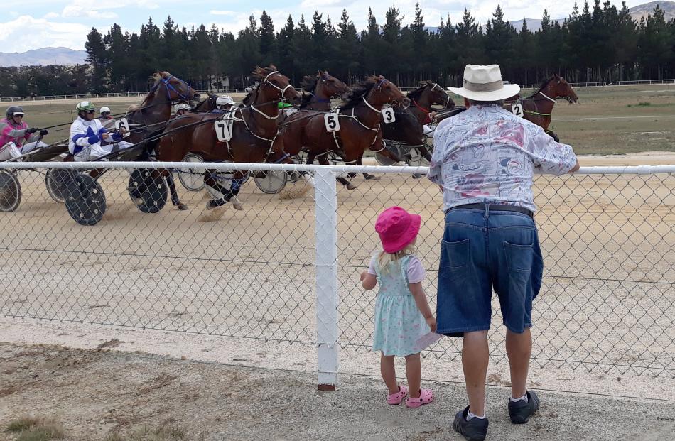 Payton McElrea (3) and her Pop, Barrie Keach, both of Balclutha, watch the horses at the Roxburgh...