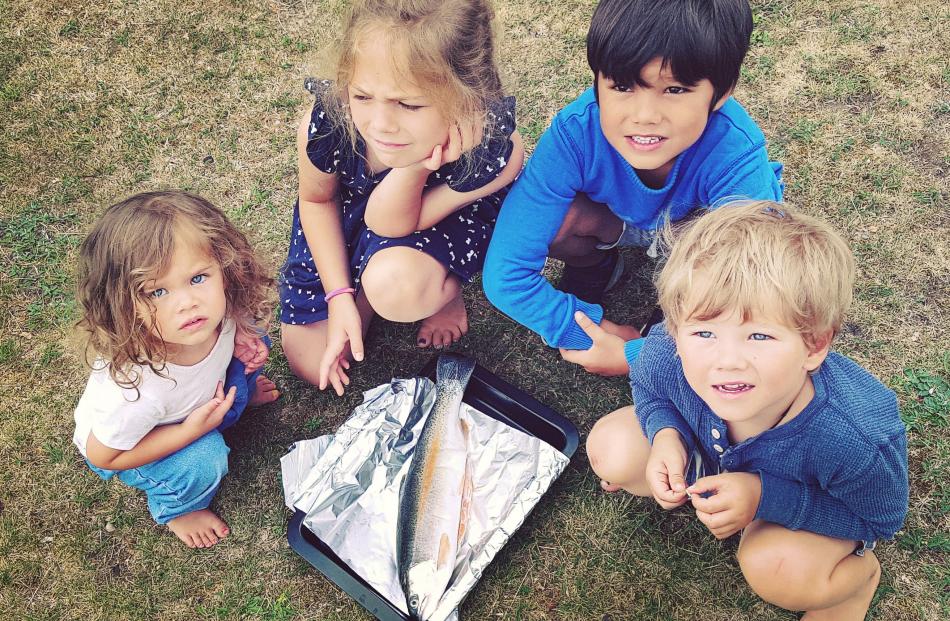 Fern, Tylah, Arie and Oliver Whiunui admire the catch of the day from Lake Aviemore. Photo:...