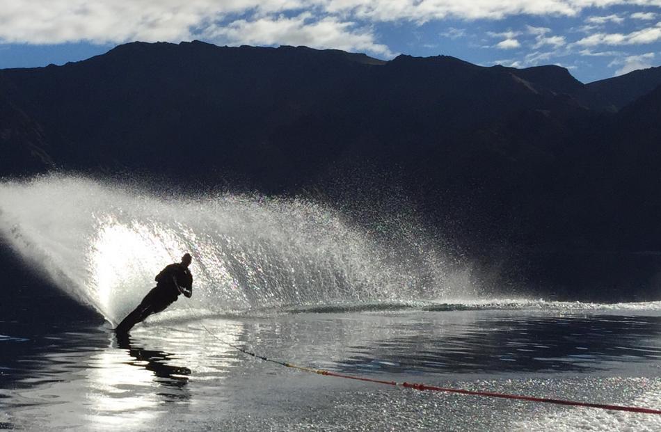 Mark Taylor (40) enjoys being the first water skier of the day on a very calm Lake Hawea on...