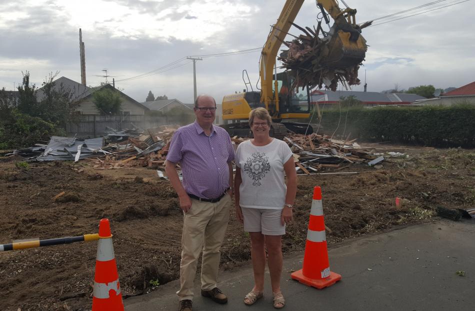 Siblings Bill Feather and Janice Pont stand in front of the demolished house in High St. Photos: Supplied