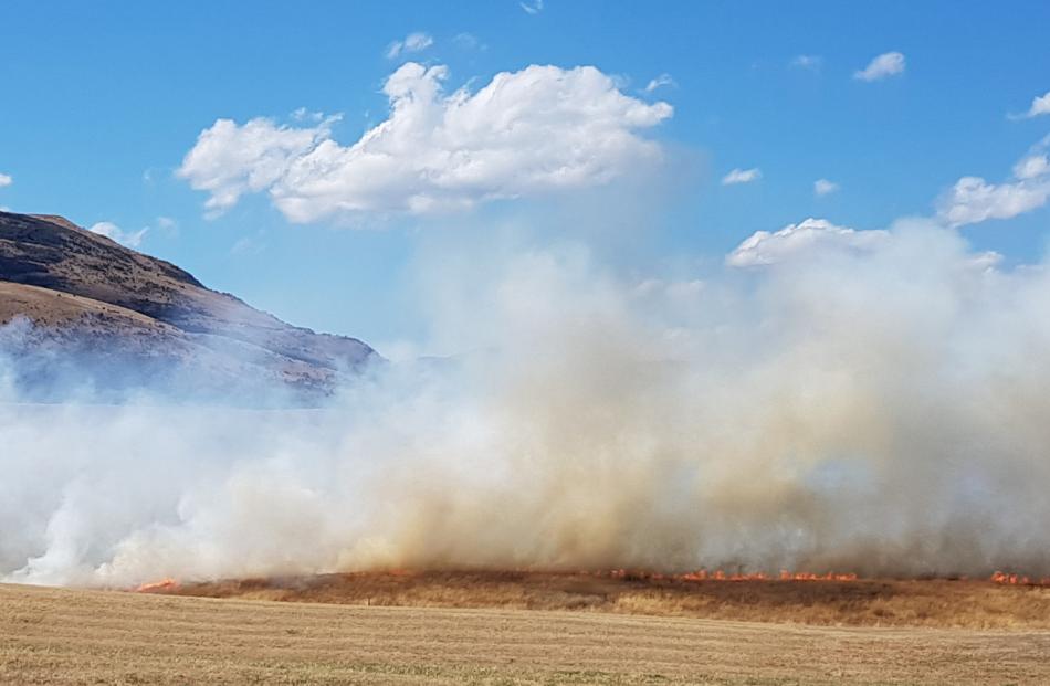 A grass fire blazes yesterday afternoon near Jacks Point, Queenstown. Photo: Alister Brown