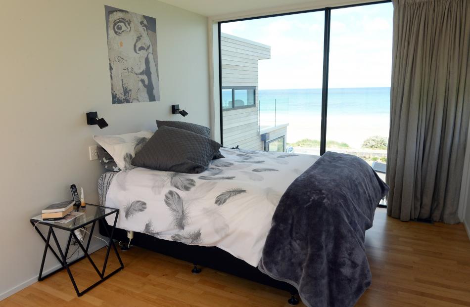 The master bedroom has ocean views in one direction and opens to the garden on the opposite side.