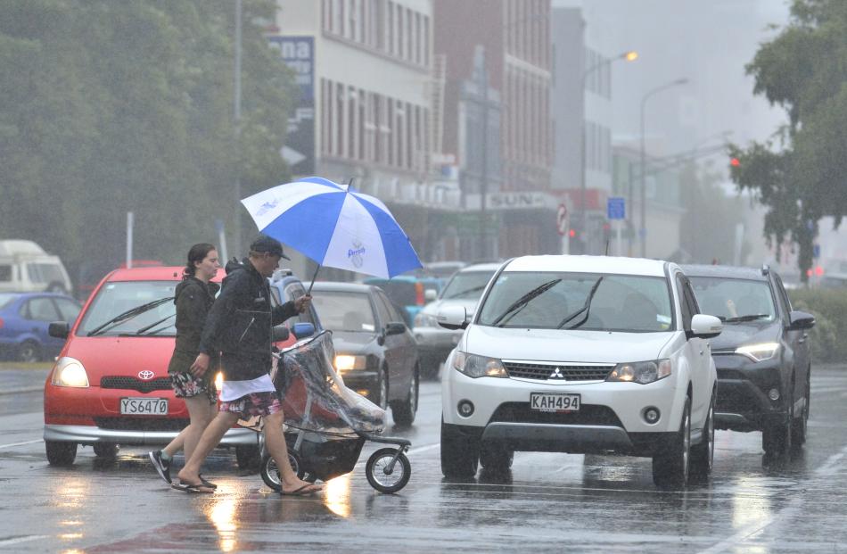 Pedestrians brave the rain in Cumberland St. Photo: Gerard O'Brien
