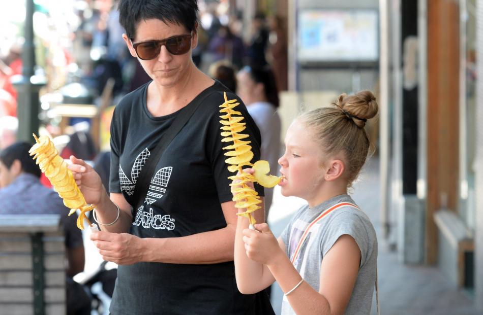 Amy Monaghan, of Mosgiel, and her daughter Arden (9) enjoy spiral potato skewers. 