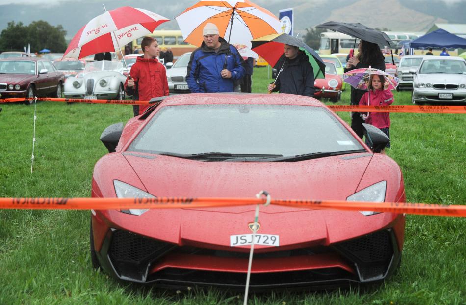 Thomas (14), Justin , Luca (12) Justine, and Amaya Farquhar (7) of Mosgiel admire a lamborghini at the Taieri Wings & Wheels Day. Photo: Christine O'Connor