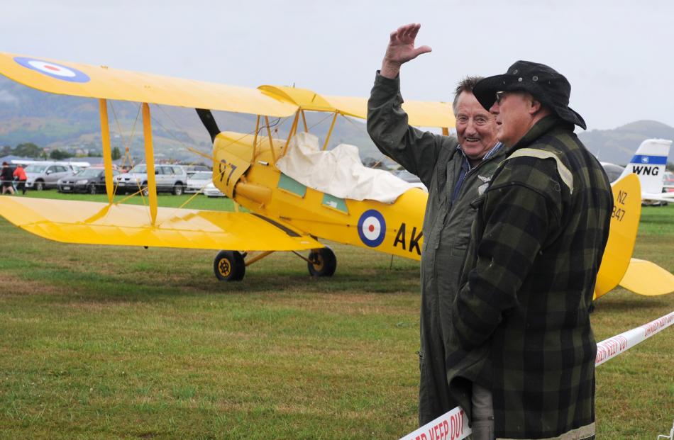 Pilot John Penno (left) explains the intricacies of a Tiger Moth to Bob Hayde at the Taieri Wings and Wheels Spectacular in Mosgiel on Sunday. Photos: Christine O'Connor